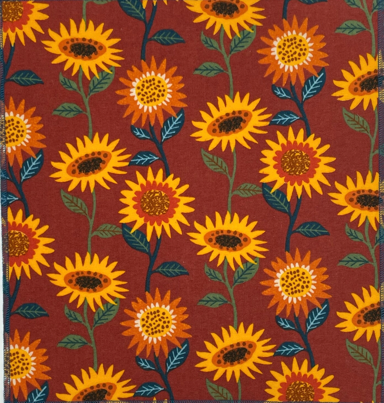 Burnt orange unpaper towel with yellow sunflwers