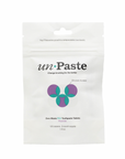 Unpaste Fluoride Tooth Tabs come in a white, compostable pouch with green and purple geometric design. This vegan, zero-waste mint formula provides 125 tablets—a two-month supply—from Unpaste.