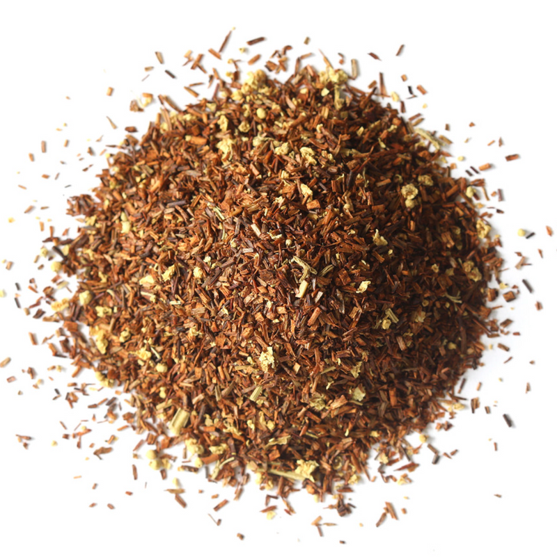 A pile of Vanilla Rooibos Herbal Tea by Mountain Rose Herbs, featuring loose rooibos leaves blended with small yellowish flower pieces, displayed on a white background.