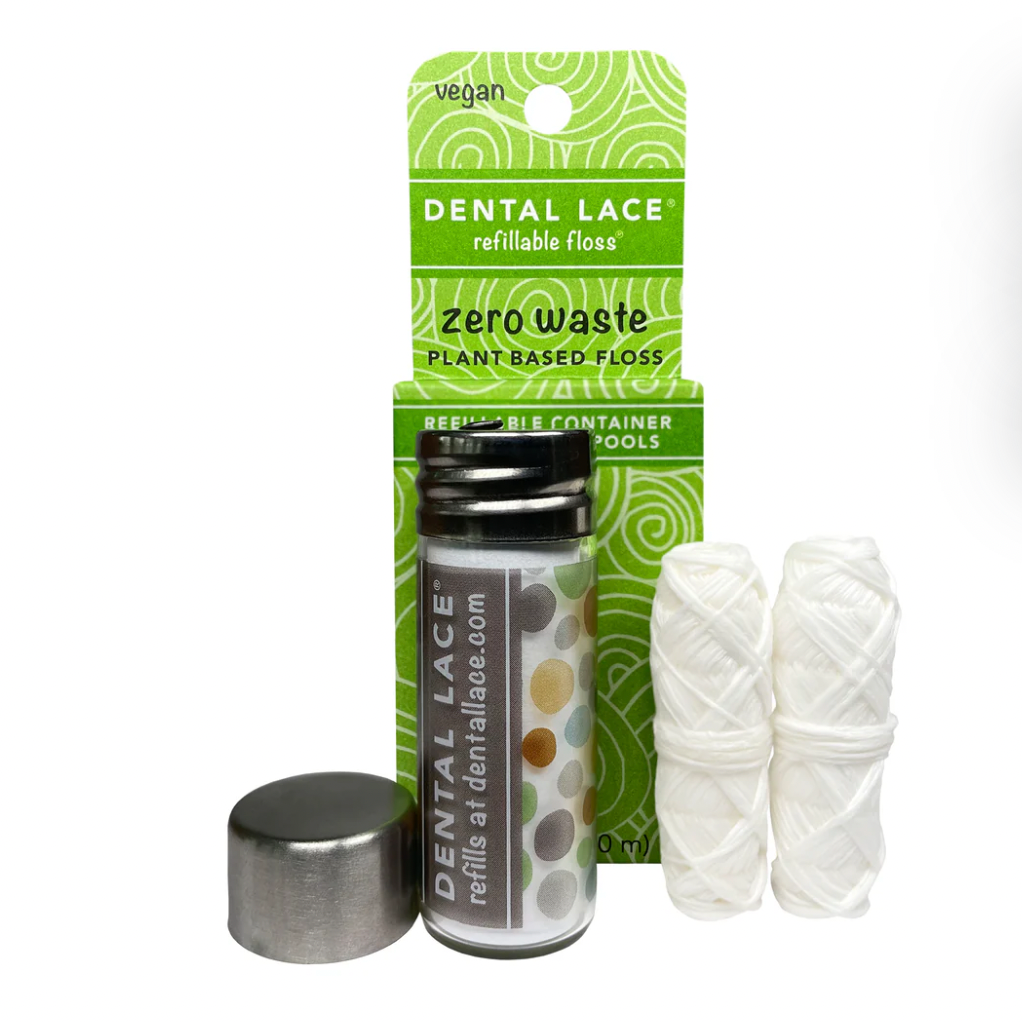 Dental Lace Vegan Compostable Floss features PLA floss in a metal-capped glass container, includes two refill spools, and comes in vegan, zero-waste, refillable packaging.