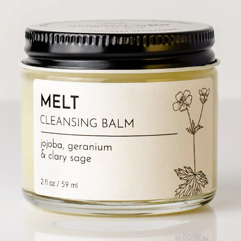 Cleansing balm jar labeled 'MELT' with a black lid on a light background
