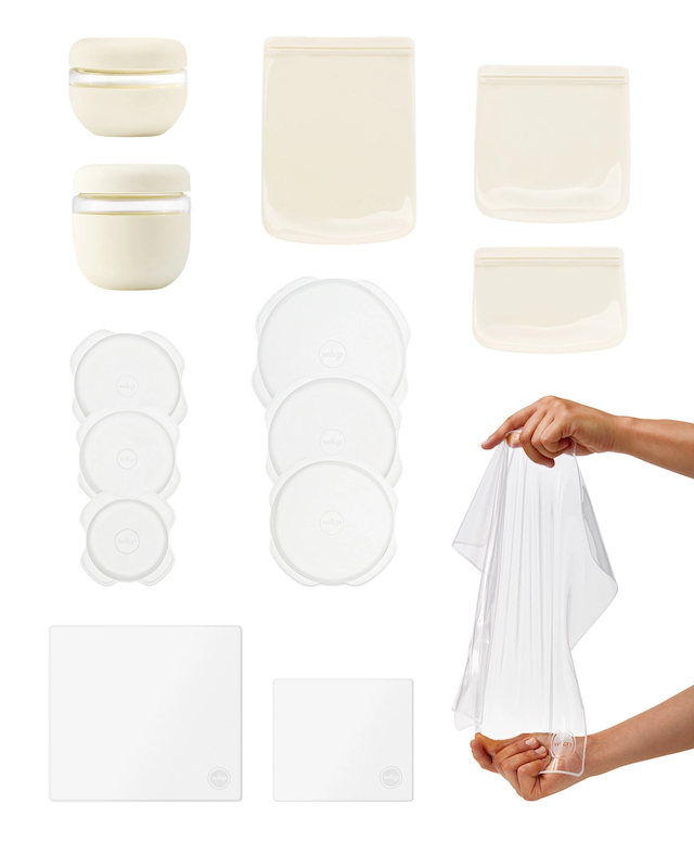 Each individual piece of the sustainable kitchen set laid out on a white backdrop. With hands stretching the reusable stretch wrap in the bottom right corner. 