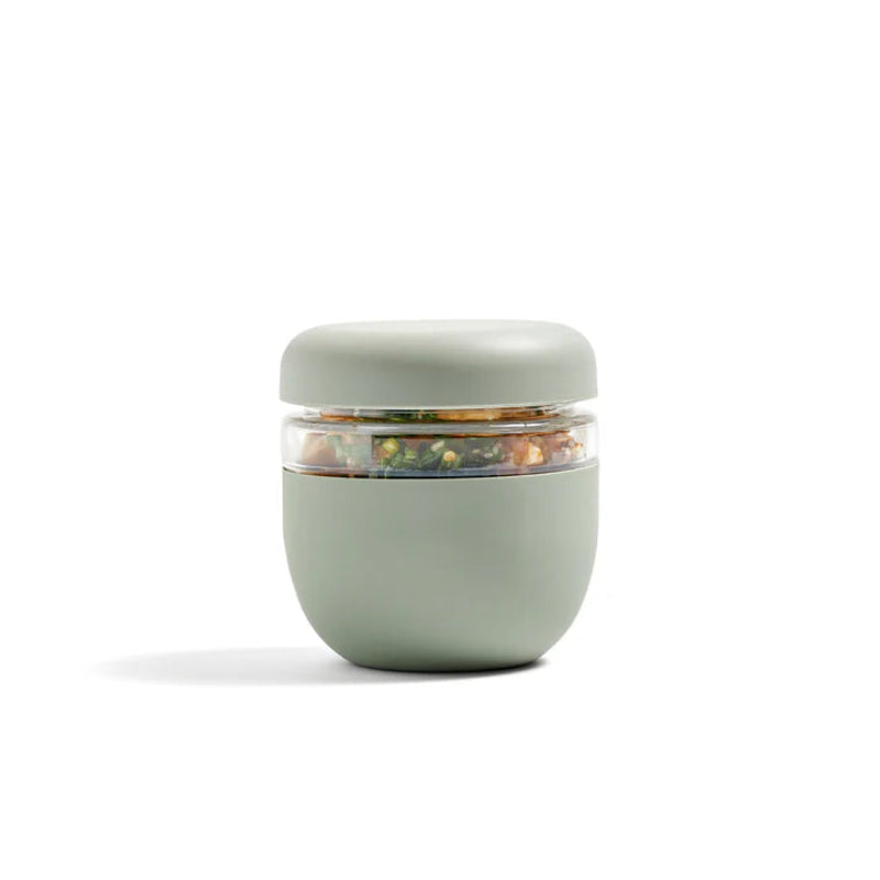 The sage green glass seal-tight bowl in the 3 cup size sitting on a white backdrop. 