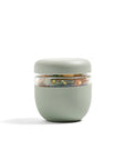 The sage green glass seal-tight bowl in the 3 cup size sitting on a white backdrop. 