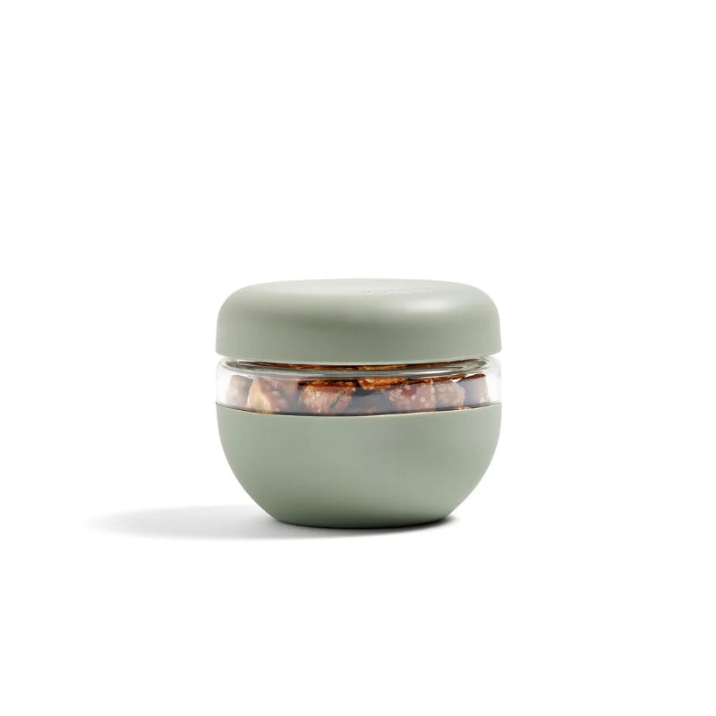 The  sage green glass seal-tight bowl in the 2 cup size sitting on a white backdrop. 
