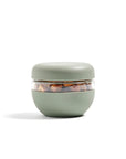 The  sage green glass seal-tight bowl in the 2 cup size sitting on a white backdrop. 