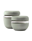 The  2 sage green glass seal-tight bowls  in the 2 cup and 3 cup sizes sitting together on a white backdrop. 