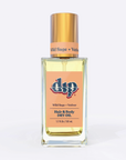 Square glass bottle with gold lid and orange label wild sage vetiver hair and body dry oil on white background. 