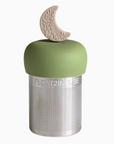 Green tea infuser with floral moon design on a white background