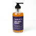 A clear bottle with a black pump, labeled Zerra & Co. Gel Face Wash, contains orange gel face wash ideal for fragrance-free skincare routines.