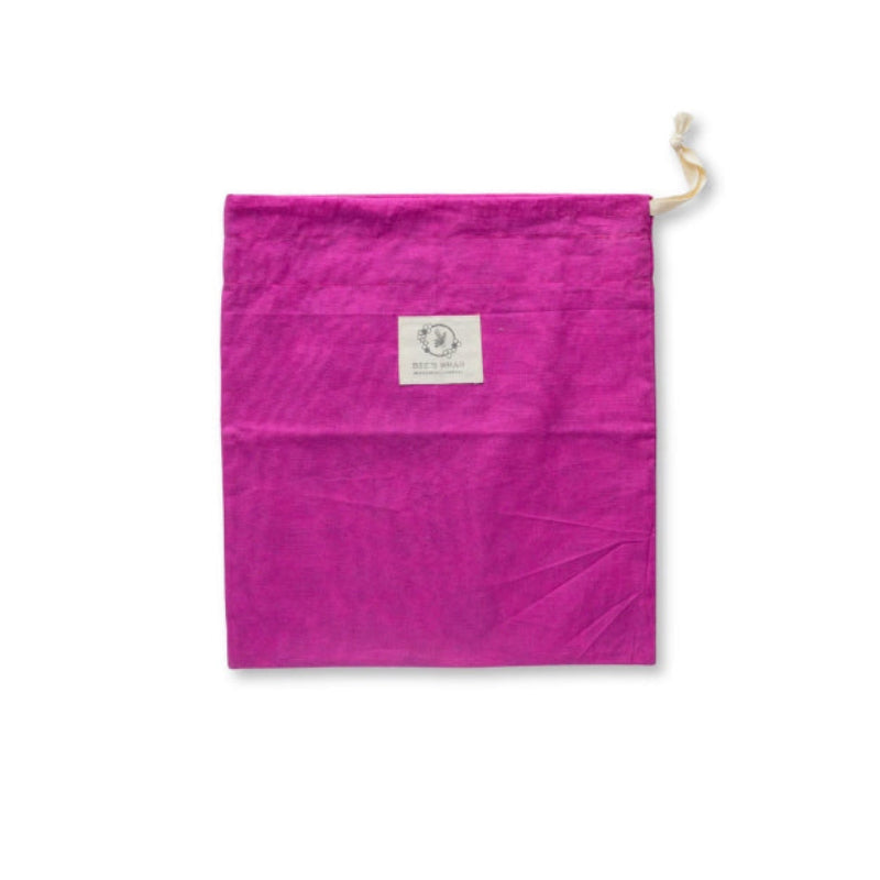 A Magenta Bee's wax lined bread bag with a drawstring top lying flat on a white background.