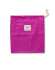 A Magenta Bee's wax lined bread bag with a drawstring top lying flat on a white background.