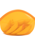 An Amber transparent reusable silicone bag holding sliced apples on a white background