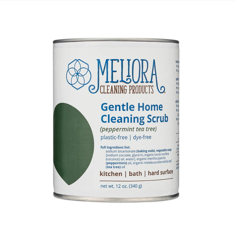 A 12 oz can of Meliora Gentle Home Cleaning Scrub on a plain white background. The can features a white label with blue text and a green leaf graphic.