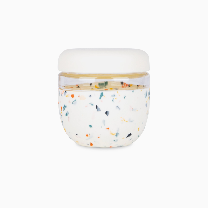 Terrazzo glass and silicone jar with white lid on white background