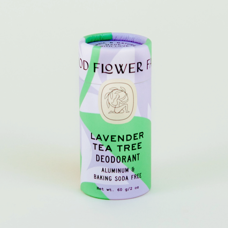 purple and green paper tube of lavender tea tree deodorant on white background 