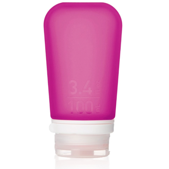 A large 3.4 oz silicone bottle in the color magenta on a white surface. 