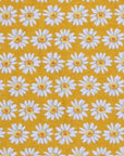Pattern of white daisies with yellow centers on a mustard yellow background