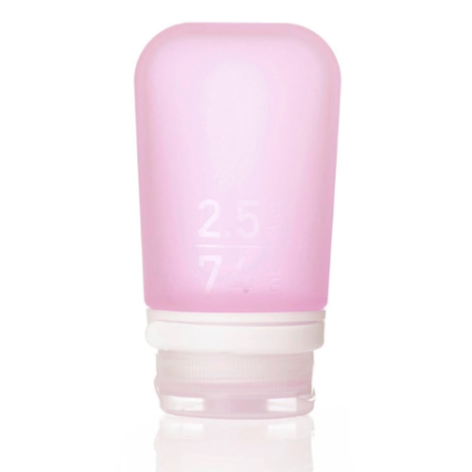 A medium 2.5 oz silicone bottle in the color pink on a white surface. 
