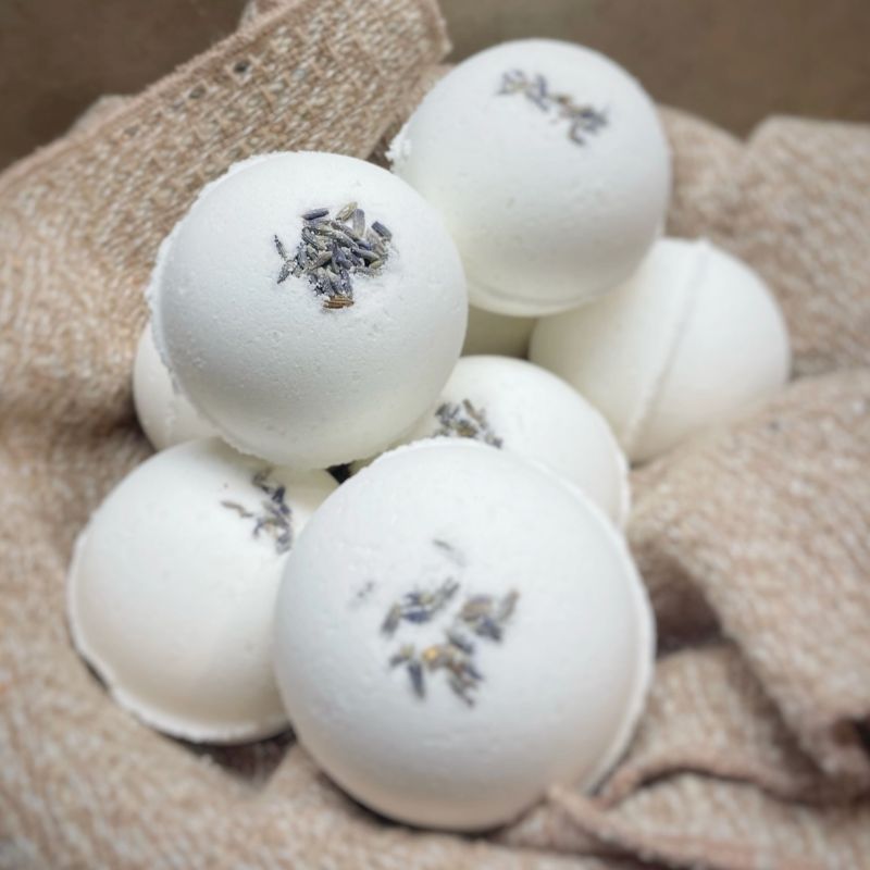 brown basket of white bath bombs with lavender buds on top