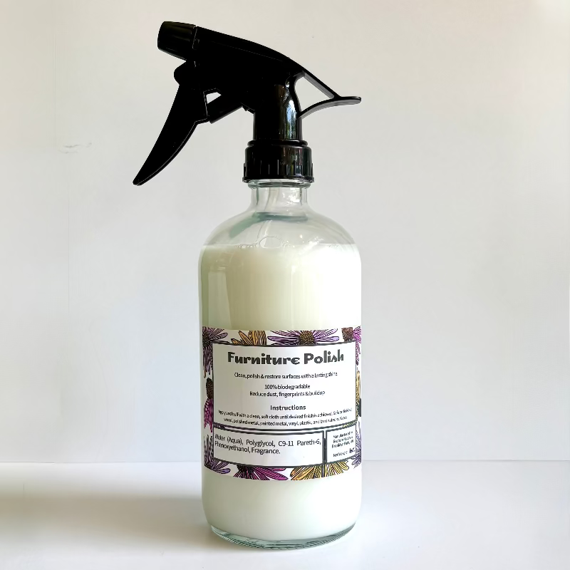 Furniture polish spray bottle with a label on a white background