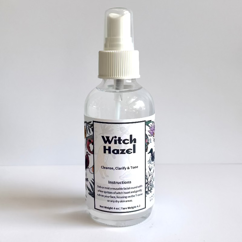 Clear spray bottle labeled 'Witch Hazel' on a white background