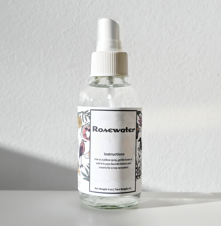 mist bottle of rose water on white backdrop