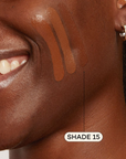 Dark skinned woman featuring Dark foundation swatched on cheek