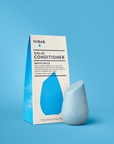 Solid conditioner bar and packaging on a blue background