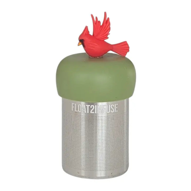 The Teany Tiny Kitchen Floating Tea Infuser features a stainless steel design with a green silicone lid topped by a red cardinal, making tea steeping fun and enjoyable.