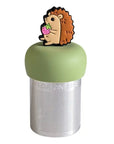 The Teany Tiny Kitchen Floating Tea Infuser features a stainless steel design with a green silicone lid topped by a cute hedgehog holding a strawberry, making tea steeping fun and enjoyable.
