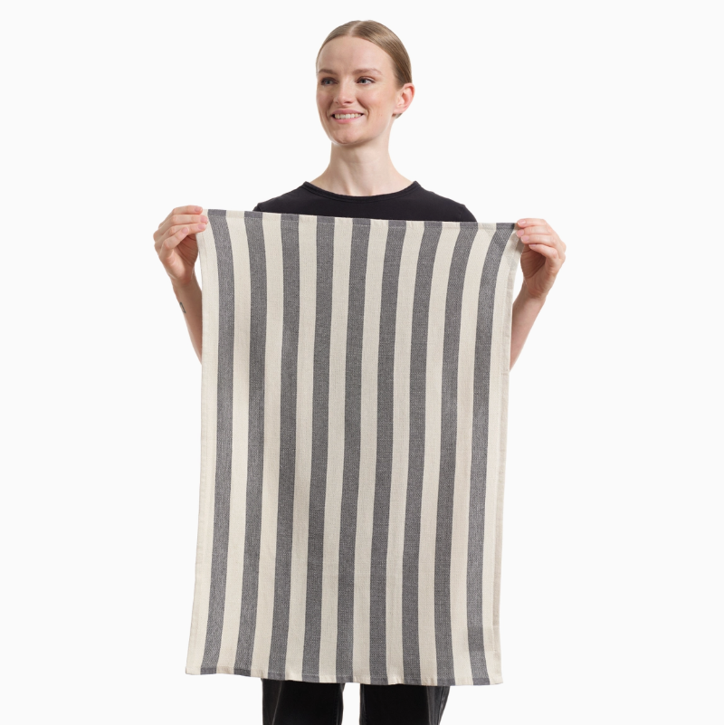 Person holding a striped towel against a white background