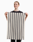 Person holding a striped towel against a white background