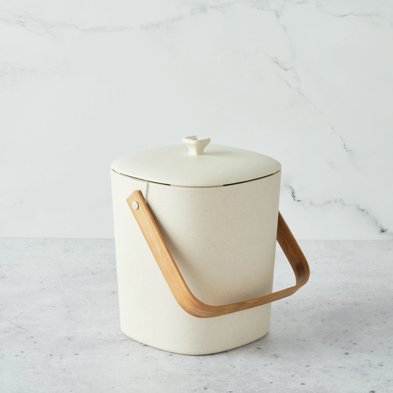 white bin with wooden handle for compost on marble background 