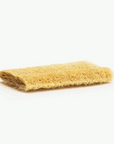 flat yellow loofah sponge on white background