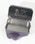 A small open metal tin with a purple exterior and a brushed silver interior. The inside lid is embossed with the brand name 'S.