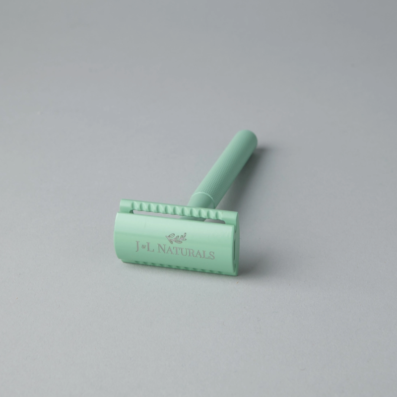 Green hair removal tool with 'J&L Naturals' branding on a gray background
