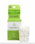 Two white rolls of Dental Lace Vegan Compostable Floss Refill sit in front of green packaging labeled Zero Waste, 2 Floss Refills, and Vegan Refills, showcasing its eco-friendly design and commitment to sustainability.