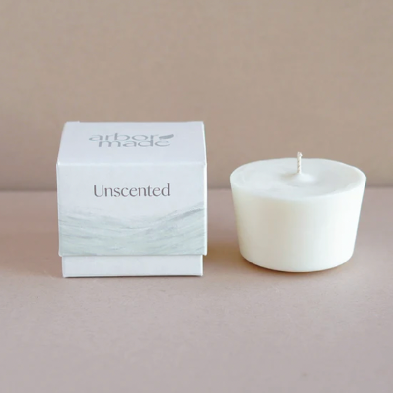 An Arbor Made Candle Refill in the Unscented Scent. The white box is sitting on a table with the refill next to it. 