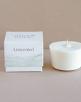 An Arbor Made Candle Refill in the Unscented Scent. The white box is sitting on a table with the refill next to it. 