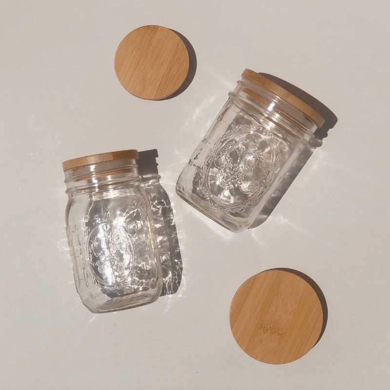A regular and wide mouth mason jar with matching bamboo lids. 