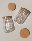 A regular and wide mouth mason jar with matching bamboo lids. 