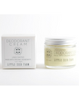 A jar of Little Seed Farm Deodorant Cream sits beside its box, both featuring a minimalist white and gray design labeled Made with Organic Ingredients. This plastic-free, handmade in Tennessee deodorant offers a natural choice.