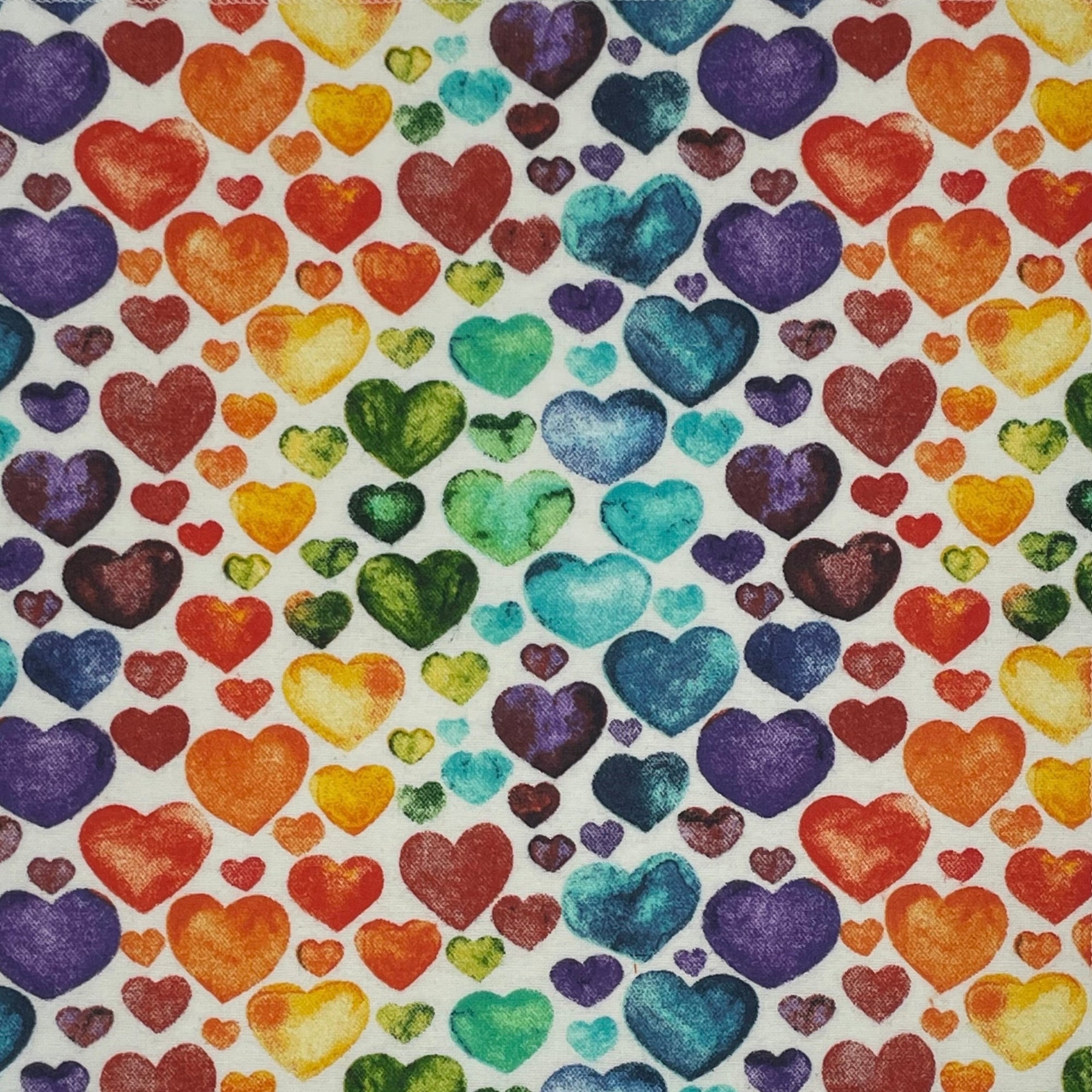 No paper towel with a rainbow of watercolored hearts on a white background. 