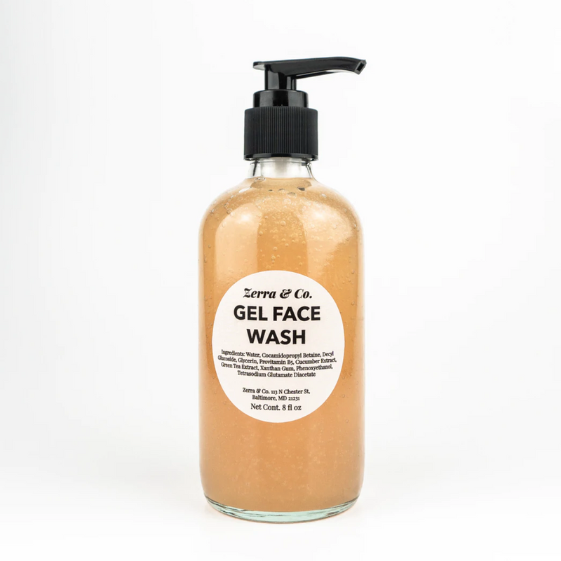 A clear bottle with a black pump, labeled Zerra & Co. Gel Face Wash, contains orange gel and ingredient details on the front—ideal for fragrance-free skincare routines.